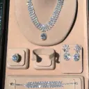 Luxury floral motif necklace, earring, ring, and bracelet set - with large oval-shaped zircon stones, rhodium plated.
